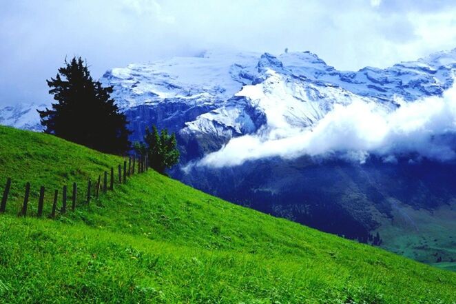 SCENIC VIEW OF MOUNTAINS AGAINST CLOUDY SKY