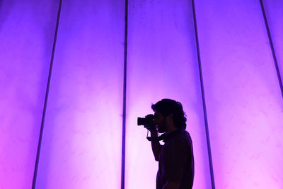 Man photographing at camera