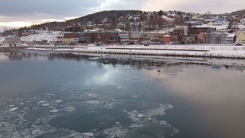 Aerial view of town by lake in city