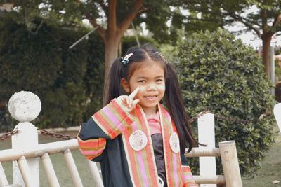 Portrait of smiling girl standing outdoors