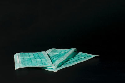 Close-up of blue paper against black background