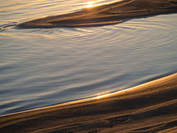 Close-up of water against sky at sunset