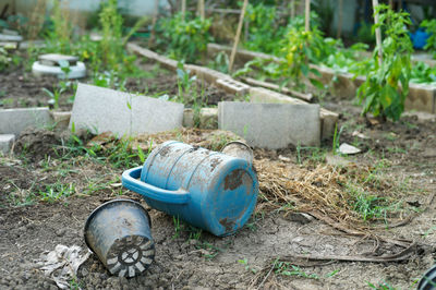 Close-up of abandoned container on field
