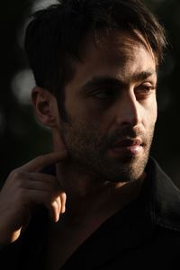 Close-up portrait of young man looking away