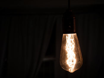 Close-up of illuminated light bulb