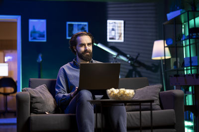 Young woman using laptop at home