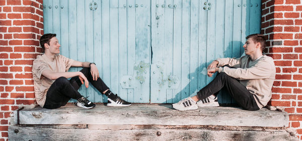 Young couple sitting on wall