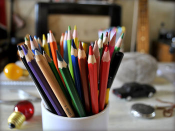 Close-up of multi colored pencils on table