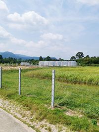 Fence on field against sky