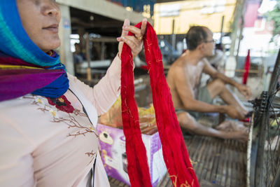 Man and woman weaving fabric at workshop