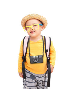 Boy wearing hat standing against white background