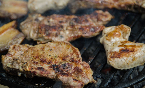 High angle view of meat on barbecue grill