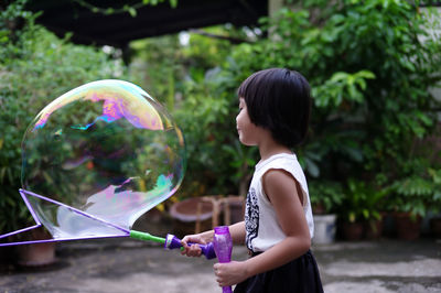 Happy girl playing with bubble