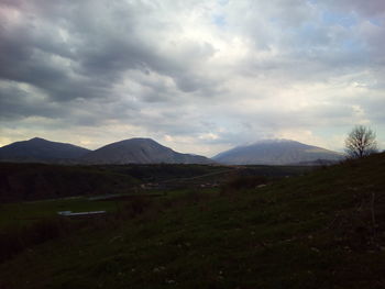 Scenic view of mountains against storm clouds