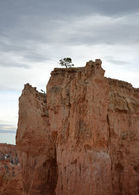 Low angle view of rock formation against sky