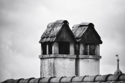 Low angle view of building roof against sky