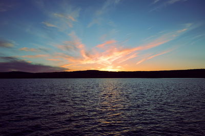 Scenic view of sea against romantic sky at sunset