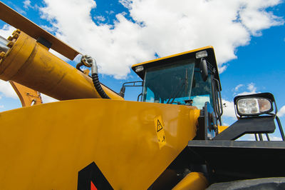 Low angle view of yellow construction site against sky