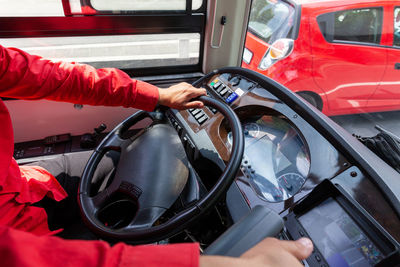 Midsection of person holding red car