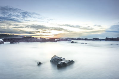 Scenic view of frozen lake against sky during sunset