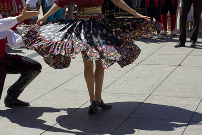 Low section of people walking on street