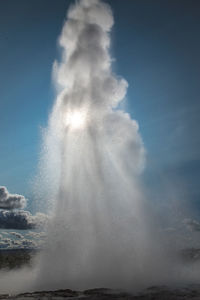 Low angle view of splashing water against sky