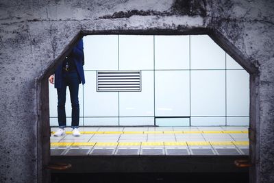 Cropped image of man waiting at station platform