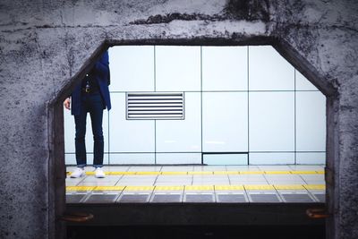 Full length of woman standing on railing