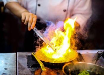 Midsection of man preparing food