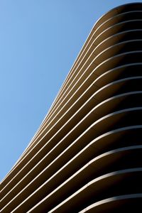 Low angle view of modern building against clear blue sky