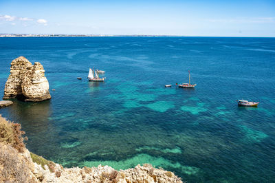 High angle view of sailboats in sea against sky