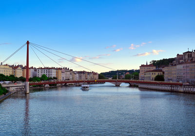 Bridge over river with buildings in background