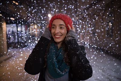 Smiling young woman wearing knit hat during winter