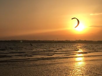 Scenic view of sea against orange sky