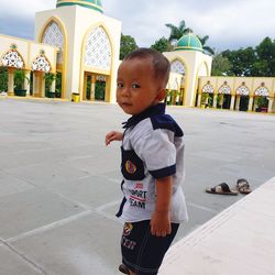 Full length of boy looking away while standing outdoors