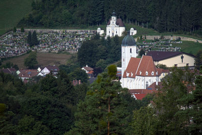 High angle view of trees and buildings in city