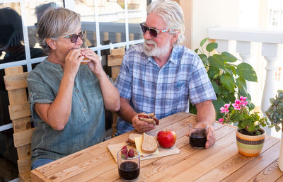 Senior couple having food at table