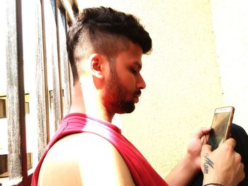 Close-up of young man using mobile phone