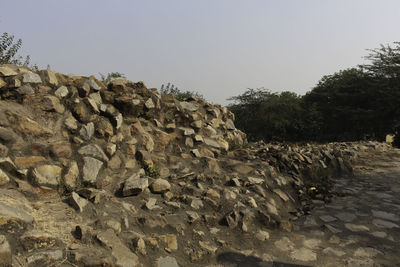 Rocks on landscape against clear sky