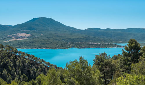 Scenic view of lake and mountains against clear sky