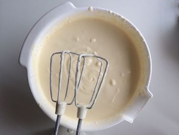 Close-up of a bowl of batter with hand mixer