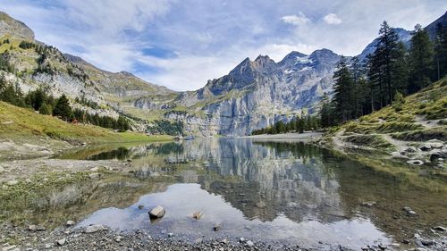 Scenic view of lake and mountains against sky