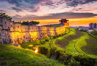 Panoramic view of historic building against sky during sunset