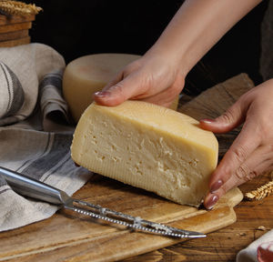 Midsection of person preparing food on cutting board