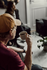 Man having coffee during office meeting