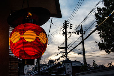 Low angle view of illuminated lanterns against sky