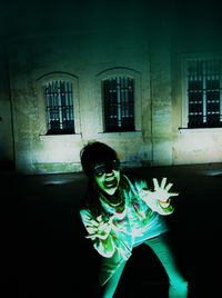 Man standing by window at night