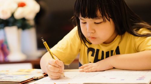 Close-up of child writing