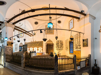 Low angle view of illuminated chandelier hanging in building