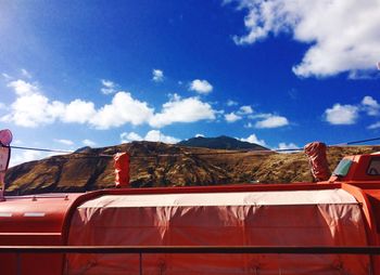 Cars on mountain against sky